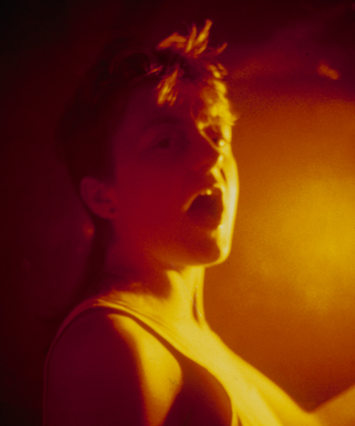 woman with an open mouth in a dark room