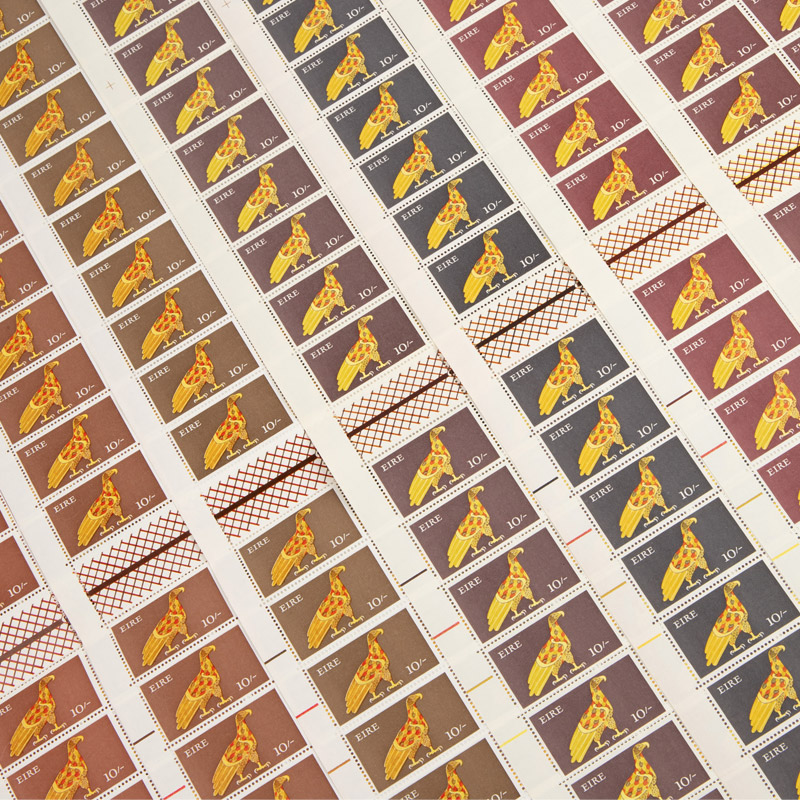 Sheets of Irish postage stamps featuring a stylized golden bird design, arranged in a grid with varying colour backgrounds and decorative borders.